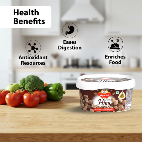 Container of 106 No, Compounded Hing Cubes with health benefits listed and vegetables on a kitchen counter