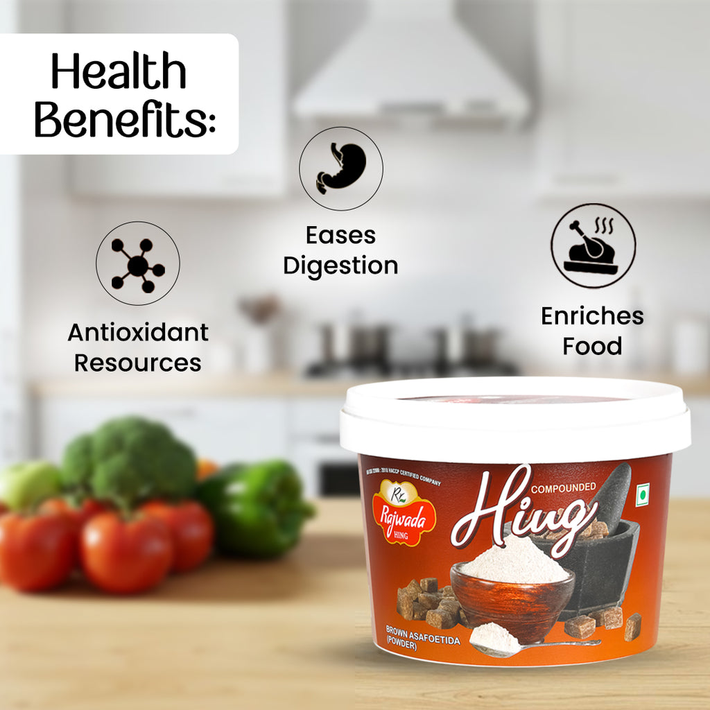 Container of compounded hing- rajwada hingwith health benefits listed on a blurred kitchen background