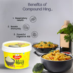 Container of compound hing- Rajwada Hing with benefits listed and a bowl of food in the background