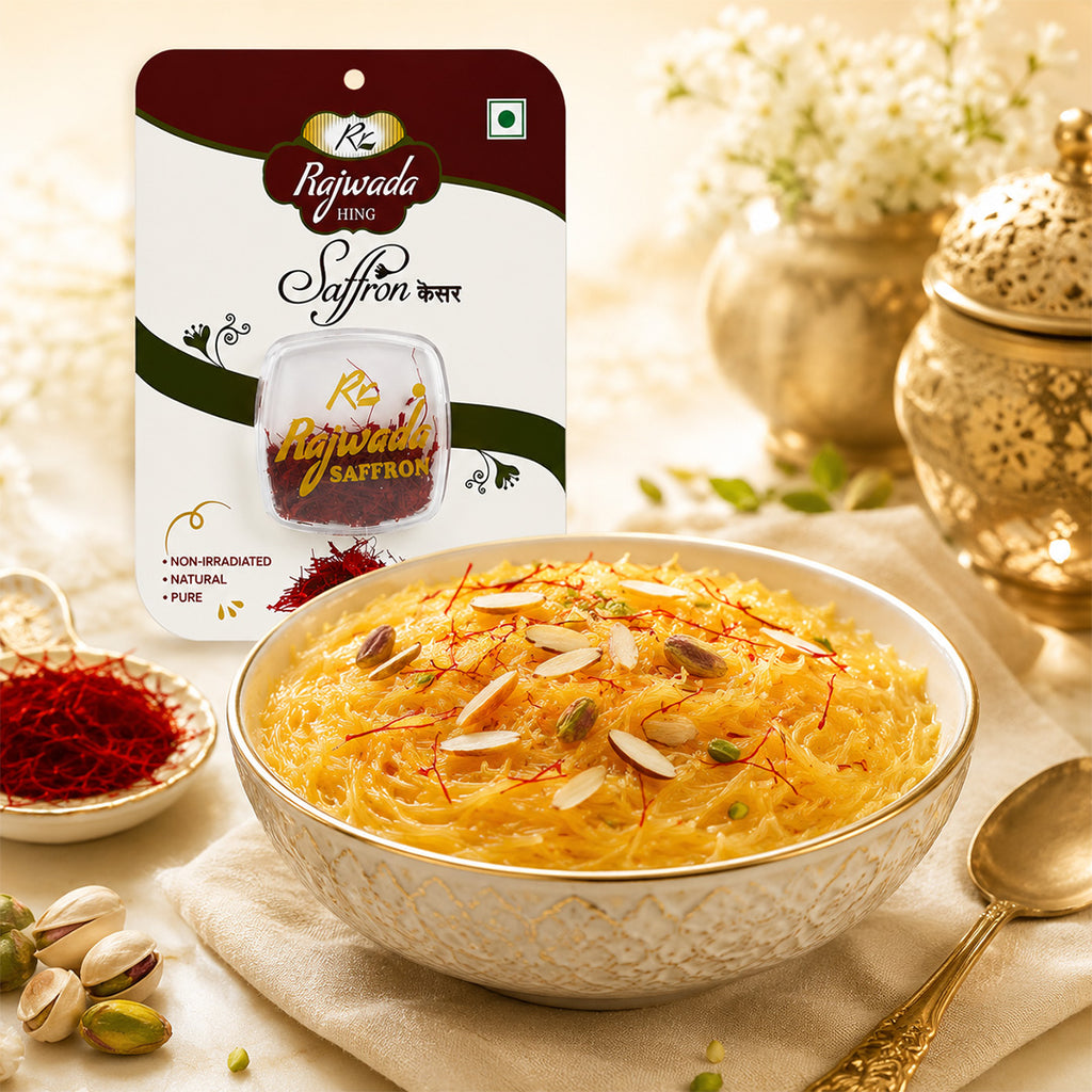 A bowl of yellow saffron kheer topped with sliced almonds and red saffron threads, with a package of Rajwada Saffron Kheer standing behind it on a styled tabletop.