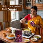 Woman in a kitchen adding Sanyukt Bandhani Hing Powder  to food with a focus on a spice container.
